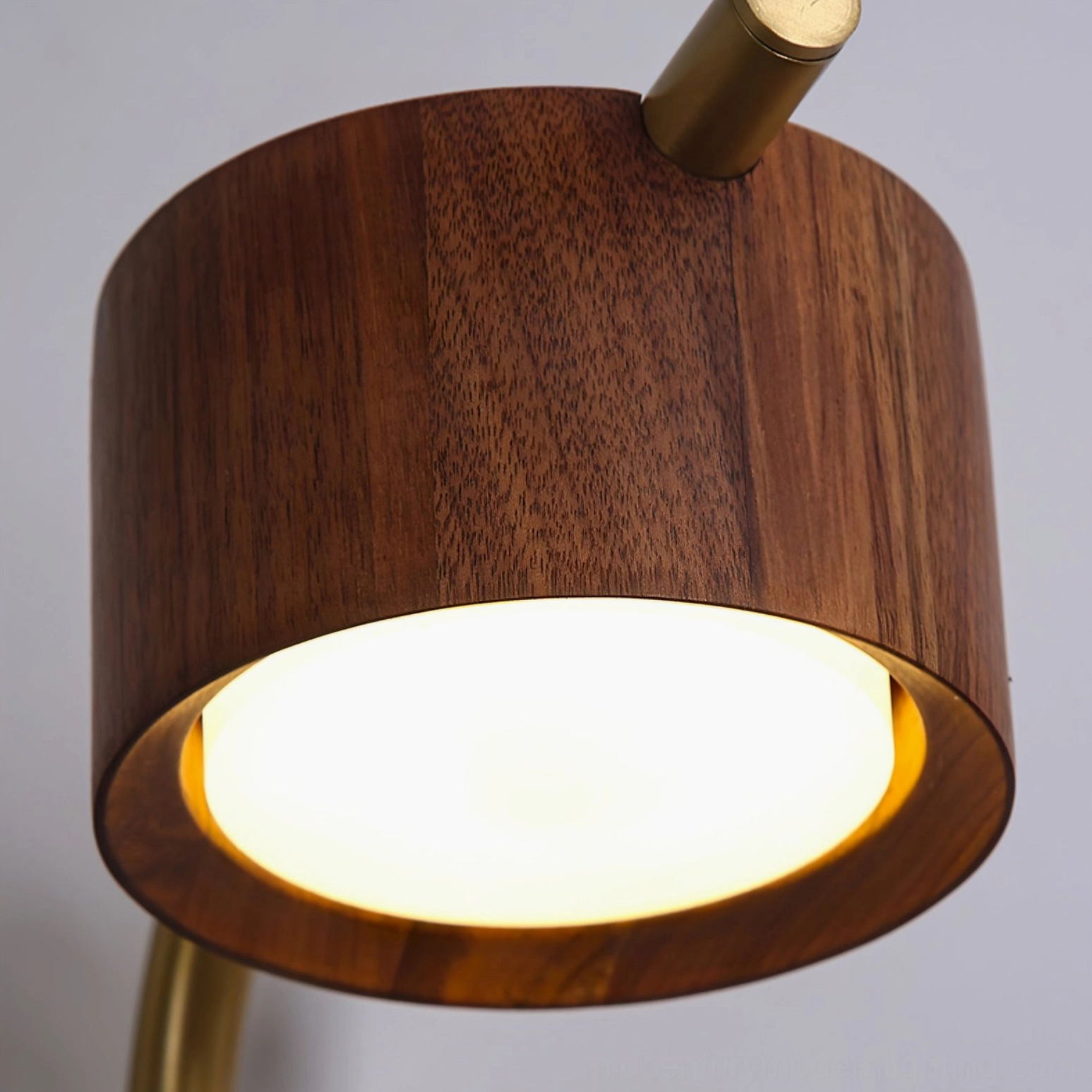Close-up detail of Terence wood head showing walnut grain texture and frosted LED light diffusion panel