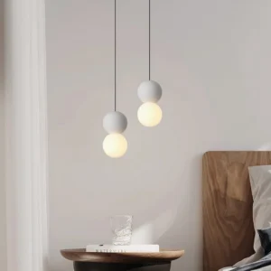 Dual terrazzo ball pendant lights in bedroom setting, warm ambient lighting