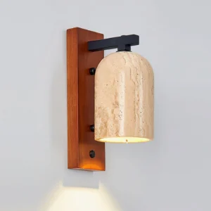 Tersus wall sconce mounted on off-white wall with warm LED light illuminating natural travertine texture