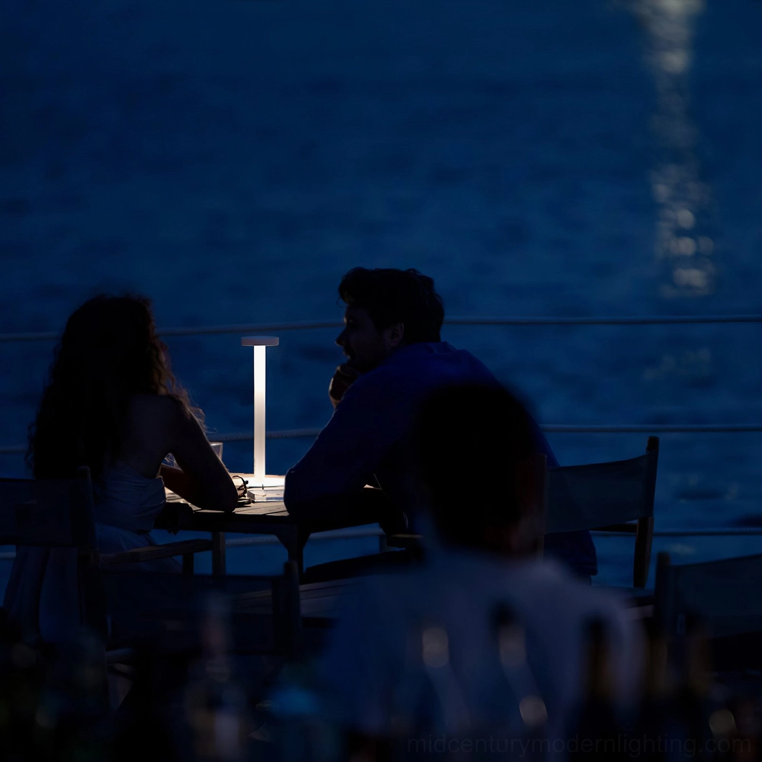 Tetatet portable lamp family seaside night dining intimate ambiance over-shoulder view
