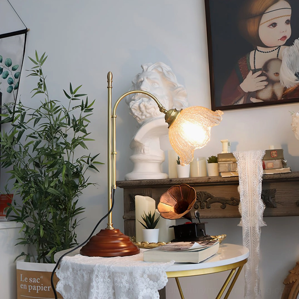 Unlit textured glass table lamp in home studio with plants and wall decor, side view showing ruffled shade