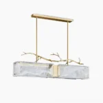 Thalassa linear glass branch chandelier overhead view showing dual rectangular marbled glass shades with brass hardware on white studio background