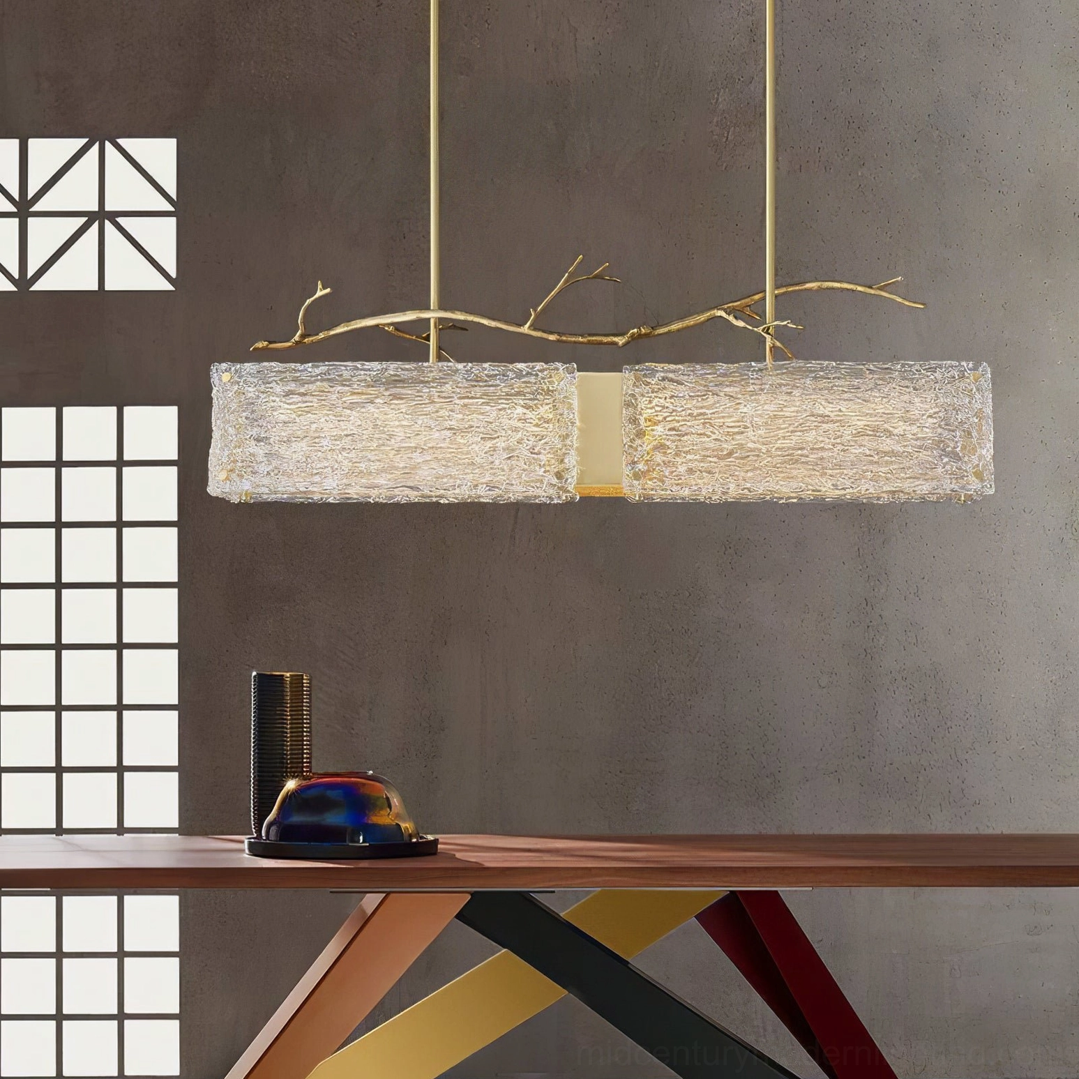 Thalassa linear glass branch pendant light in minimalist modern office space with gold suspension rods and textured clear glass