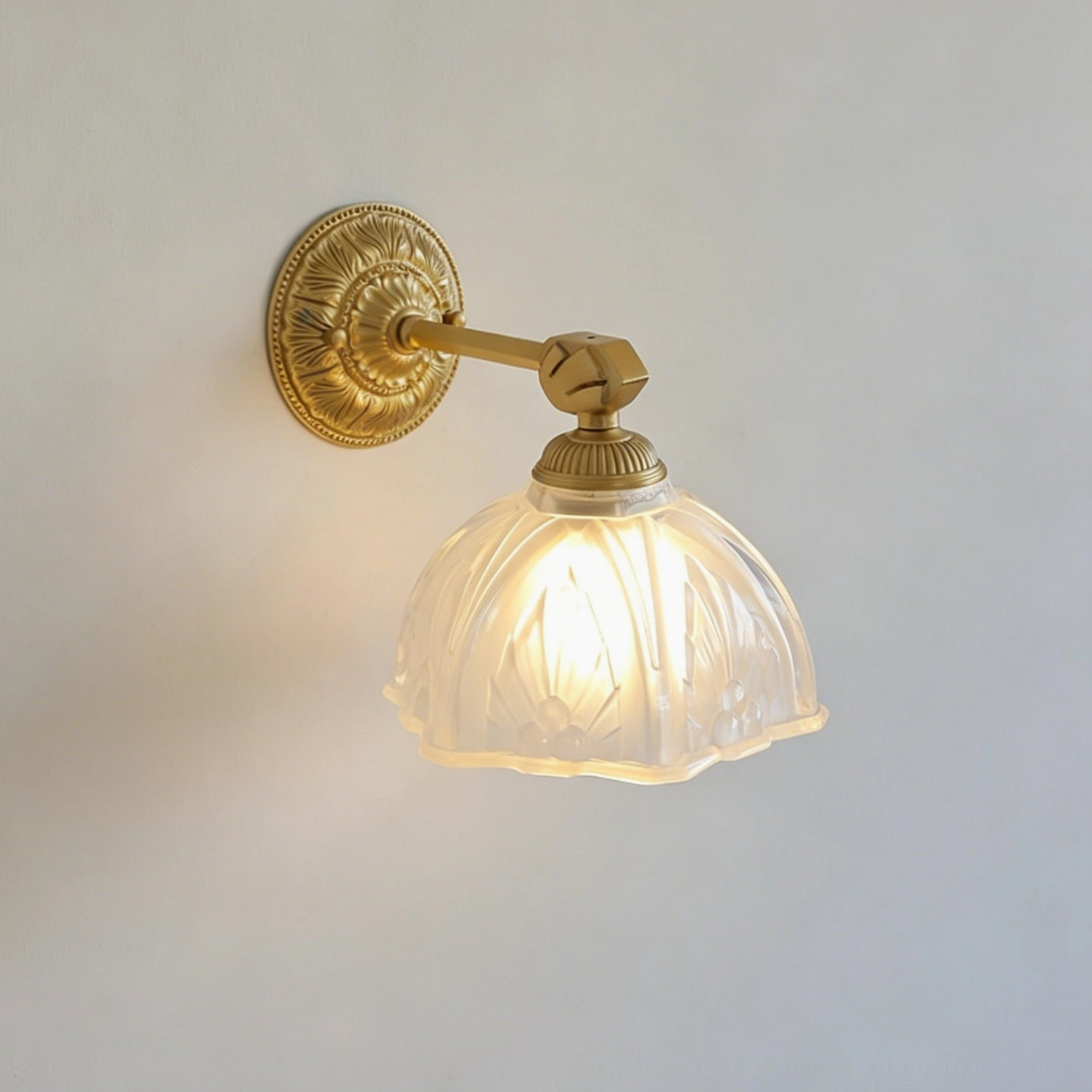 Thayer brass wall sconce product shot showcasing beaded rim and ornamental scrollwork finish
