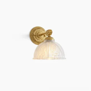 Thayer vintage brass wall sconce with ornate scrolling vine base and bell-shaped embossed glass shade, frontal view on white background