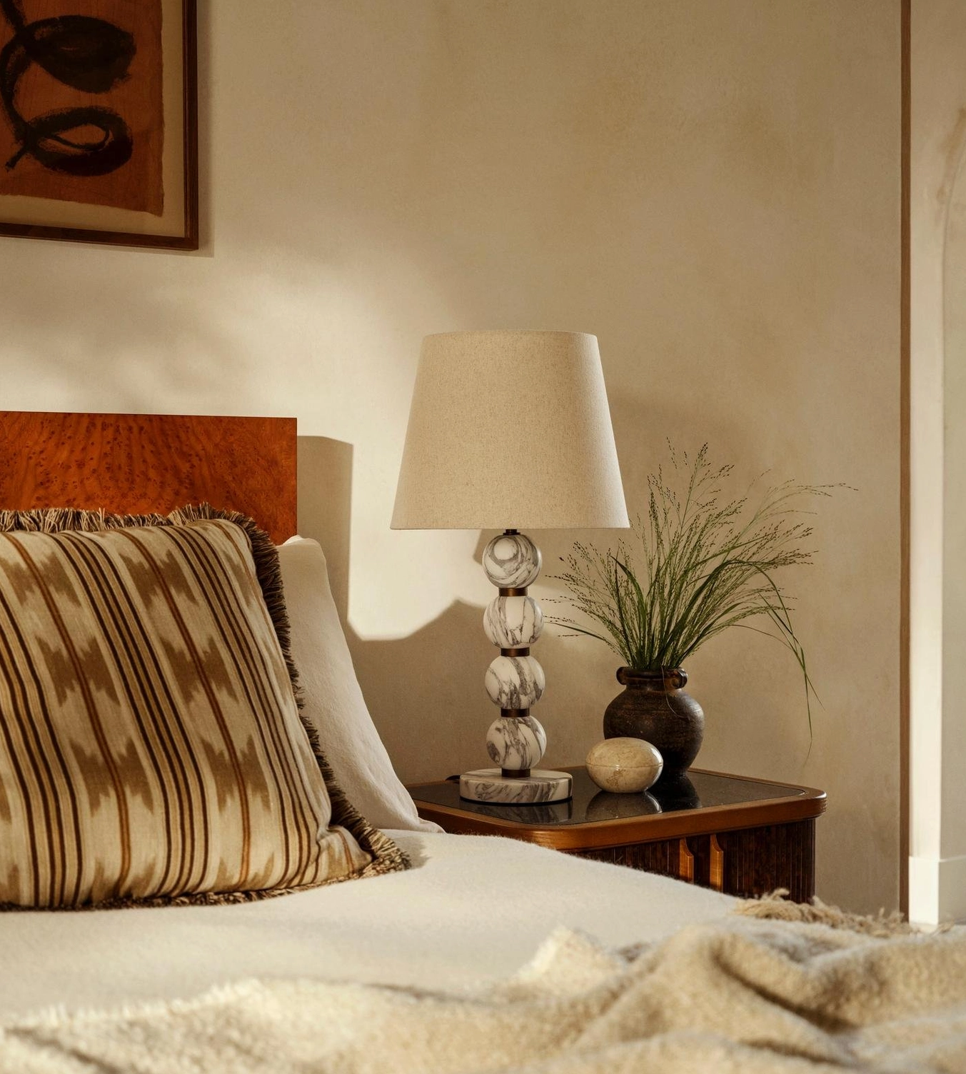 Thelma marble lamp styled on bedroom nightstand with warm neutral bedding and modern minimal decor