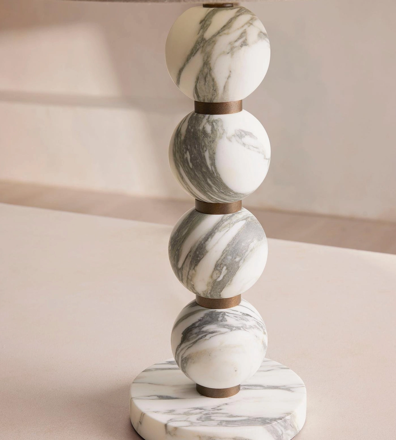 Thelma lamp side view revealing stacked marble spheres with metal collars spacing and sculptural geometry