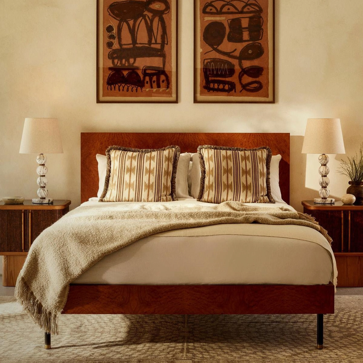 Pair of Thelma marble table lamps flanking bed in bohemian mid-century modern master bedroom