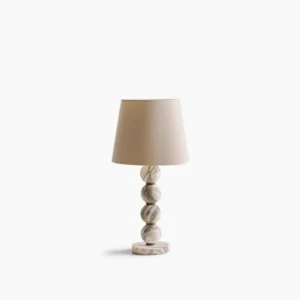Thelma marble table lamp front view with stacked marble sphere base and cream linen shade on white background
