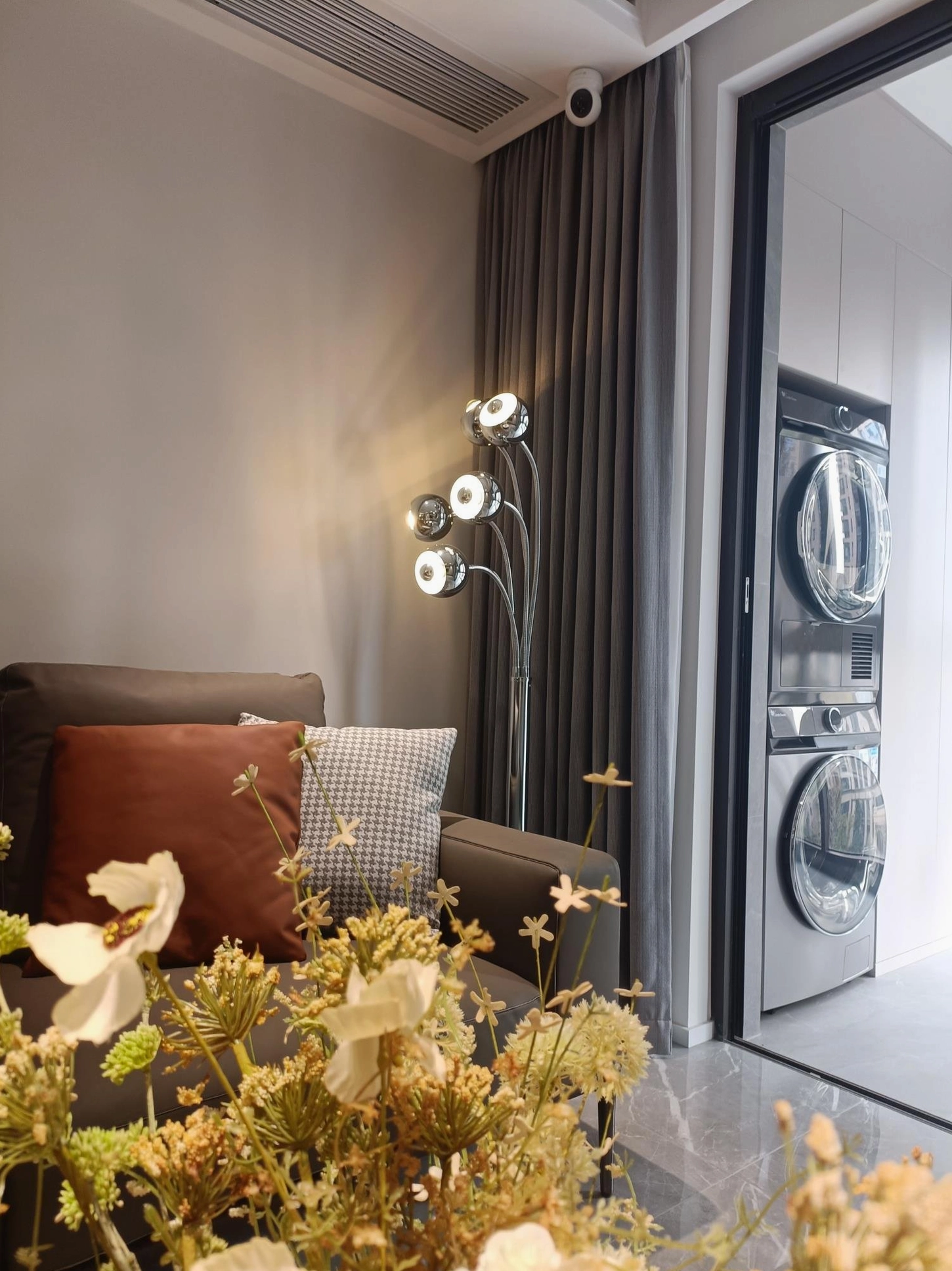 Three-head chrome eyeball floor lamp configuration in contemporary interior design space with modern furnishings