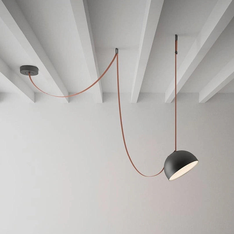 Three-head leather sling pendant lamp with black metal shade creating geometric sculptural presence
