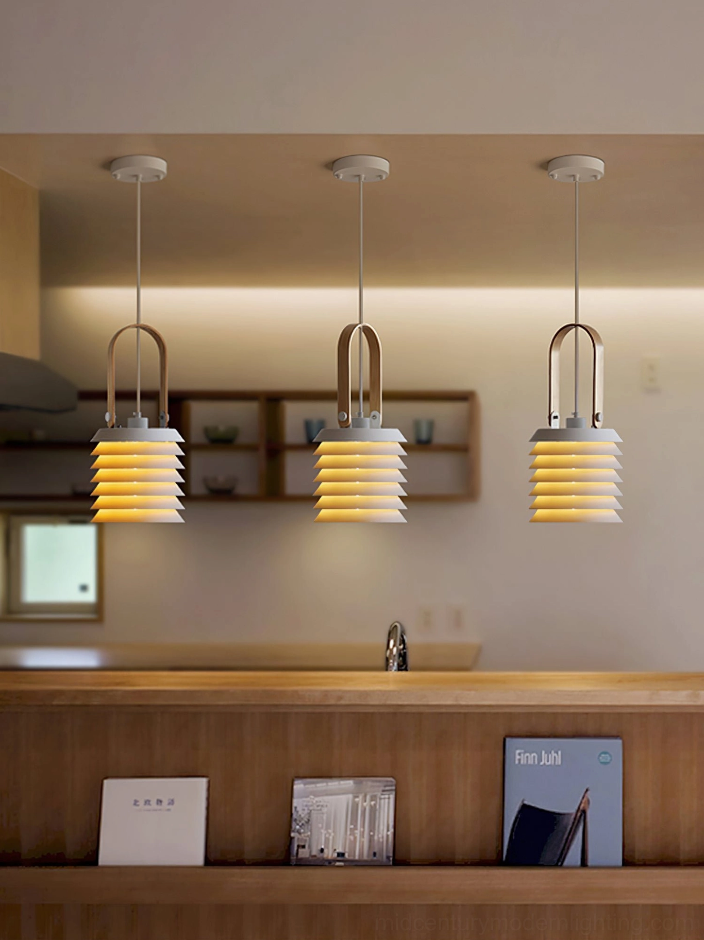Three matching honeycomb lantern pendant lamps suspended at varying heights in home kitchen