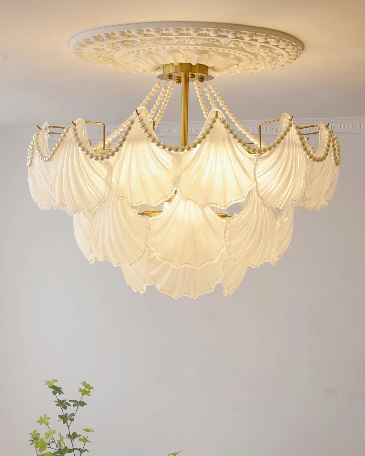 Three-layer tiered scallop shell glass chandelier with pearl detailing and warm ambient lighting effect
