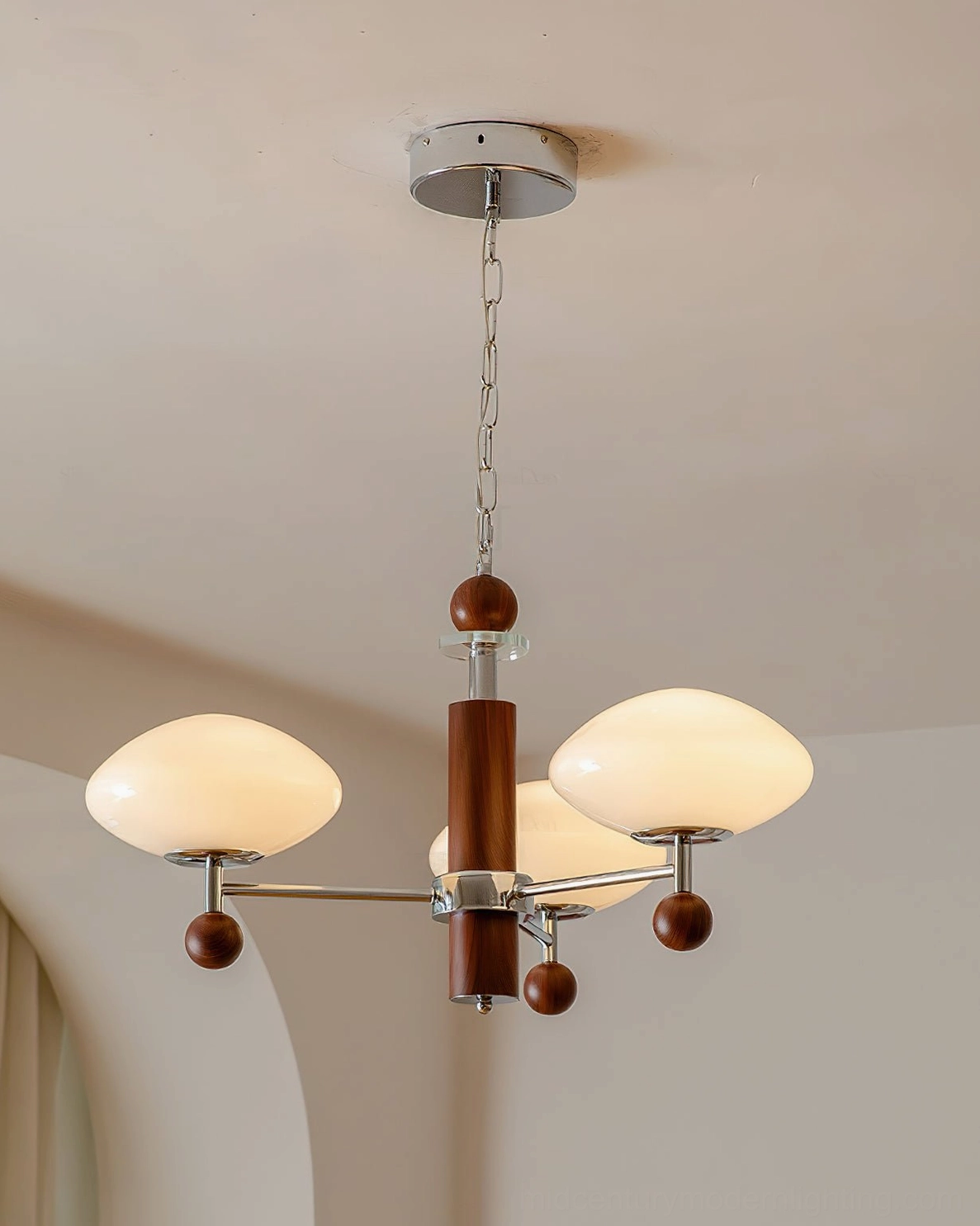 Three-light pointed chandelier bottom view close-up - studio photography showing walnut wood spheres and chrome metal construction detail