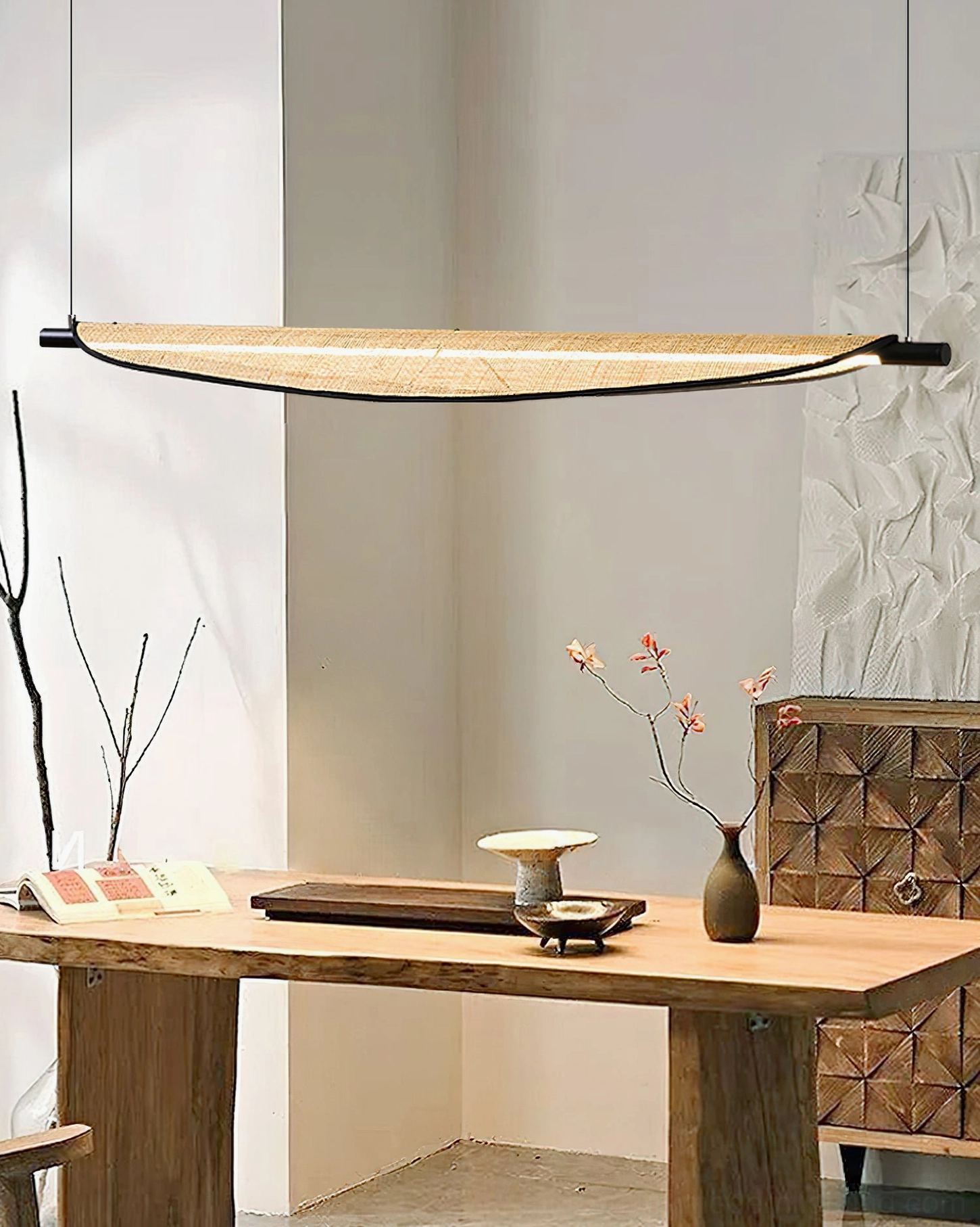 Thula pendant light over wooden tea table with wabi-sabi aesthetic and dried floral accessories