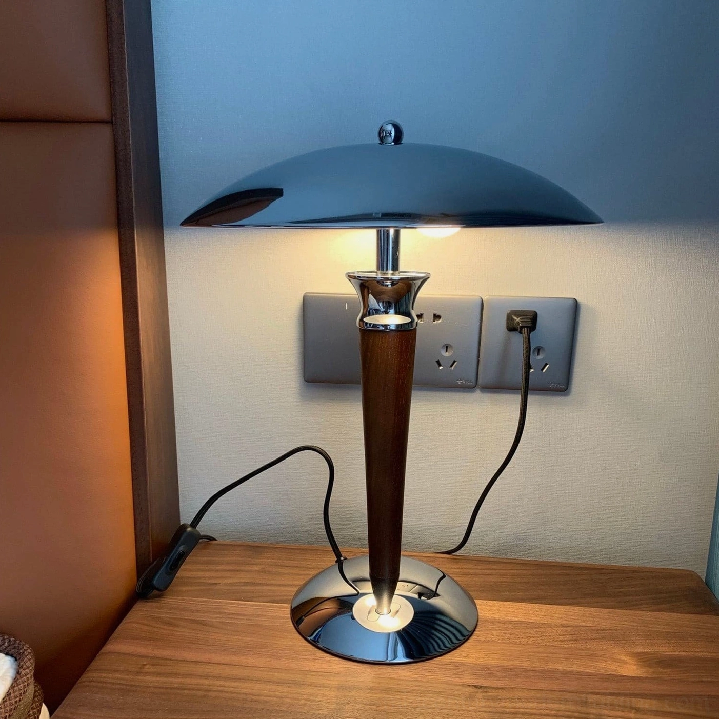 Tibby mid-century mushroom lamp glowing on bedside table providing soft reading light