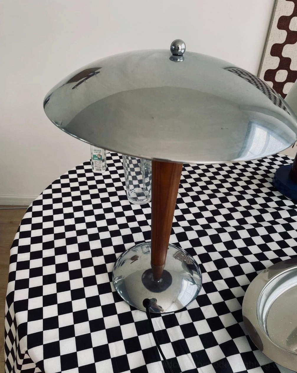Close-up detail of Tibby lamp showing polished chrome shade construction and solid wood stem craftsmanship