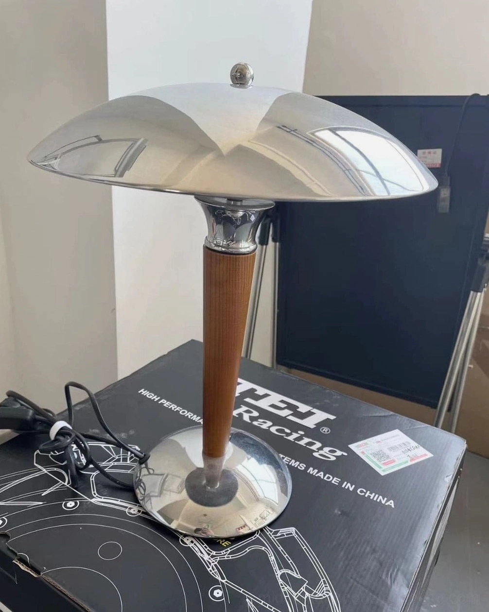 Front close-up of Tibby mushroom lamp showing polished chrome shade finish and walnut wood base quality