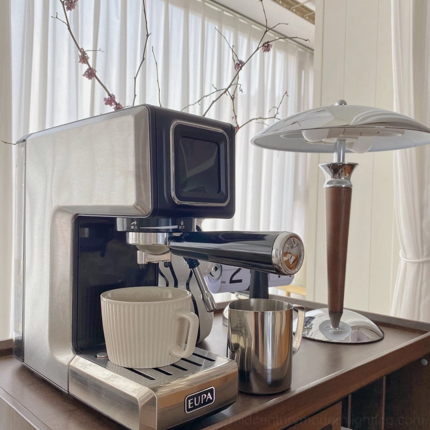 Tibby modern table lamp positioned on coffee bar countertop next to stainless steel espresso machine