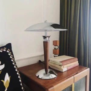 Tibby table lamp three-quarter angle on residential side table styled with stacked books and decorative wooden accessories