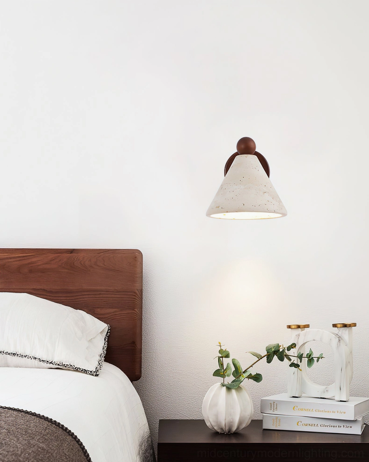 Tiber travertine bedside wall light mounted on white wall above wooden nightstand with minimal styling
