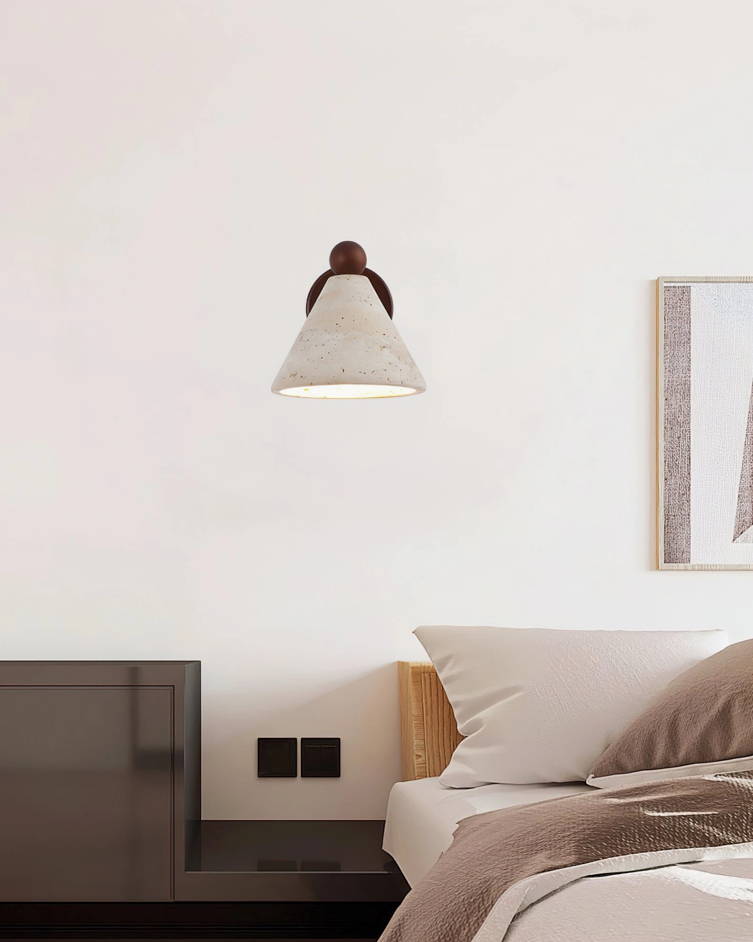 Natural stone wall sconce in contemporary minimalist bedroom with framed wall art and modern furnishings