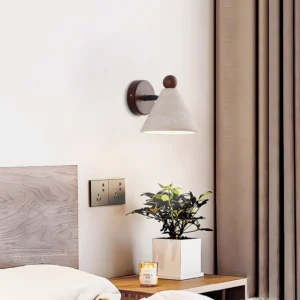 Tiber travertine wall light in modern bedroom, mounted beside bed as warm ambient bedside sconce lighting
