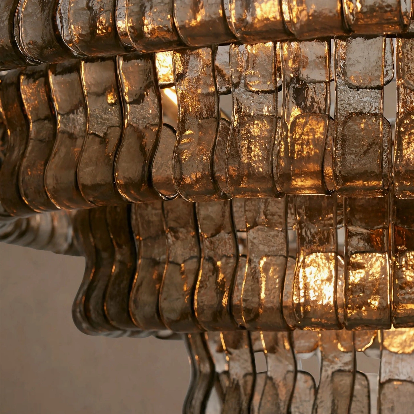 Tiered round chandelier fixture, multiple descending glass layers creating depth, dimensional lighting architectural element