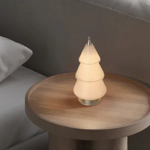 Geometric LED cone table lamp creating warm ambient glow on bedroom bedside table with side table and wood furniture