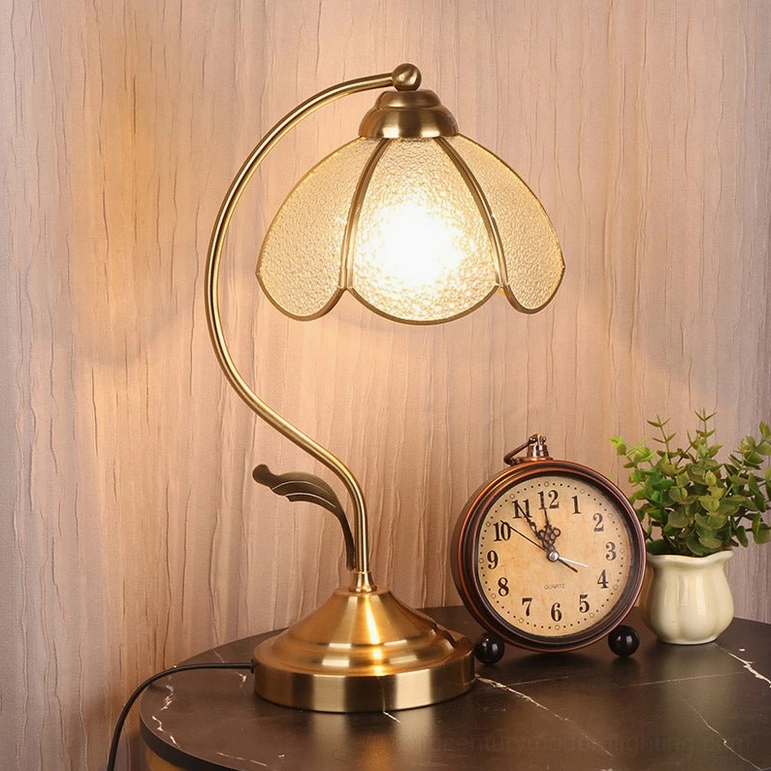 Low-angle rear view of Tiffany lamp showing weighted brass base construction and decorative leaf stem support