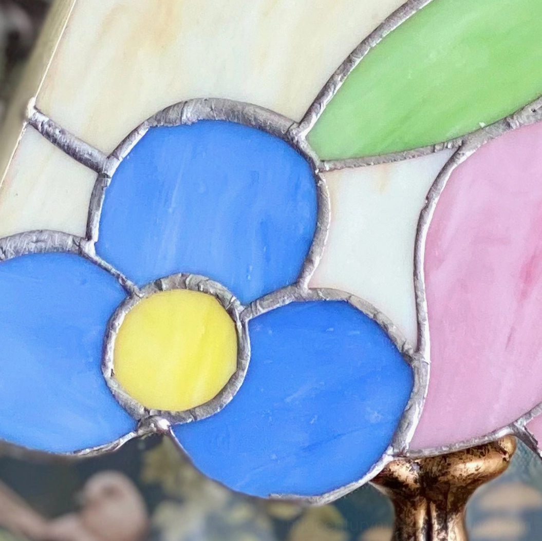 Vintage Tiffany table lamp with jewel-tone stained glass in contemporary interior setting