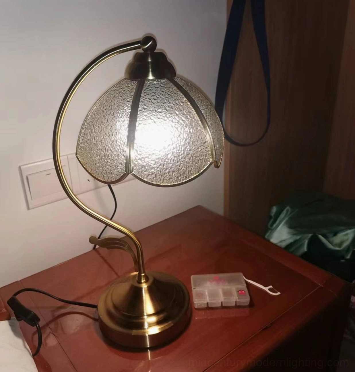 Overhead view of Tiffany table lamp displaying shade design and brass fixture details on white background