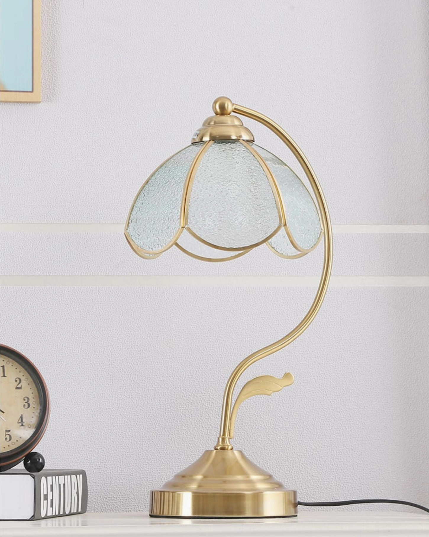 Close-up detail of Tiffany lamp shade showing frosted glass texture and polished brass trim construction