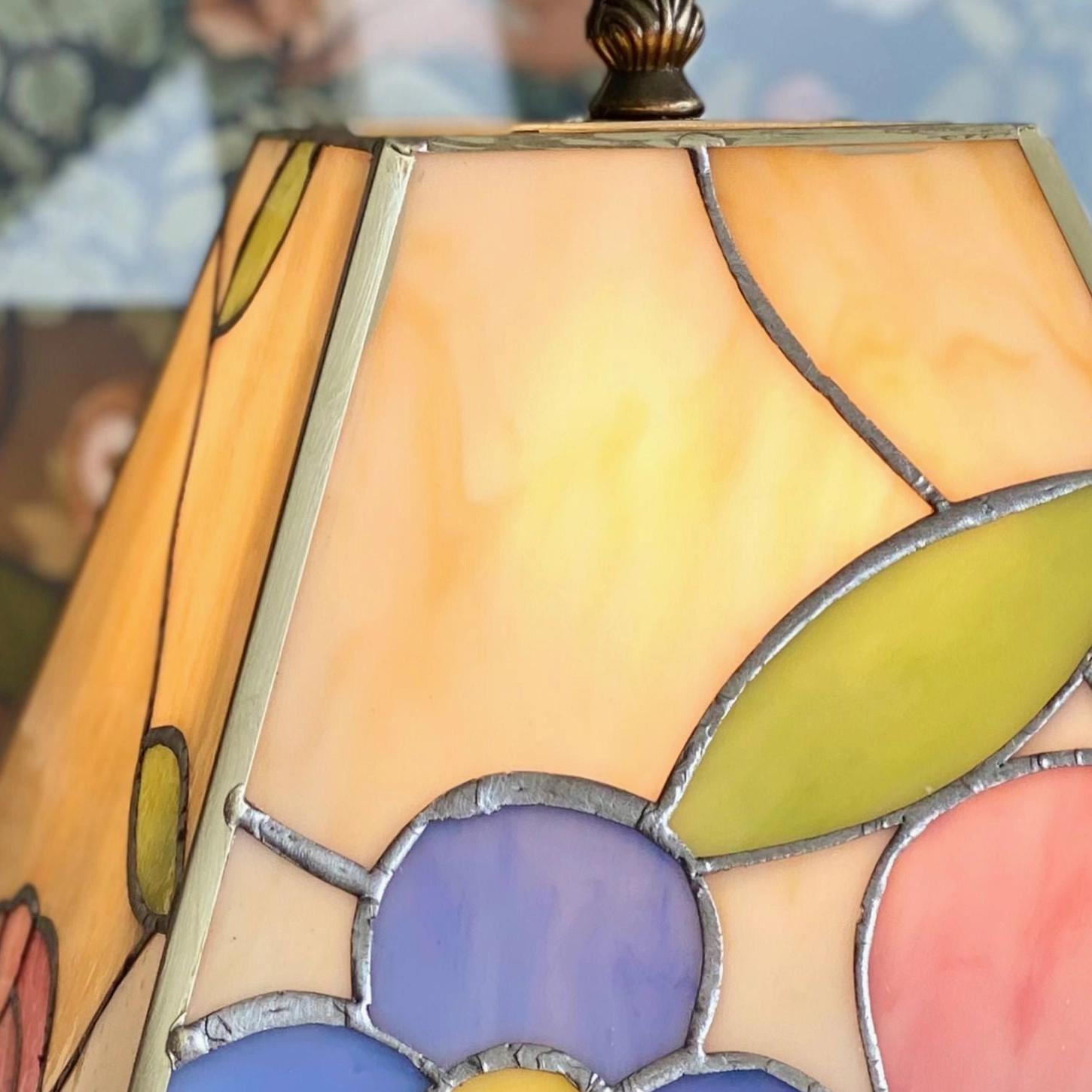 Handcrafted Tiffany glass lamp three-quarter view showing shade and bronze pedestal base