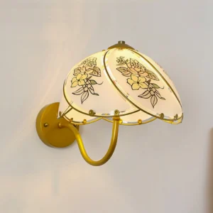 Illuminated Tiffany Lily Wall Sconce showing warm light cast through detailed floral glass pattern