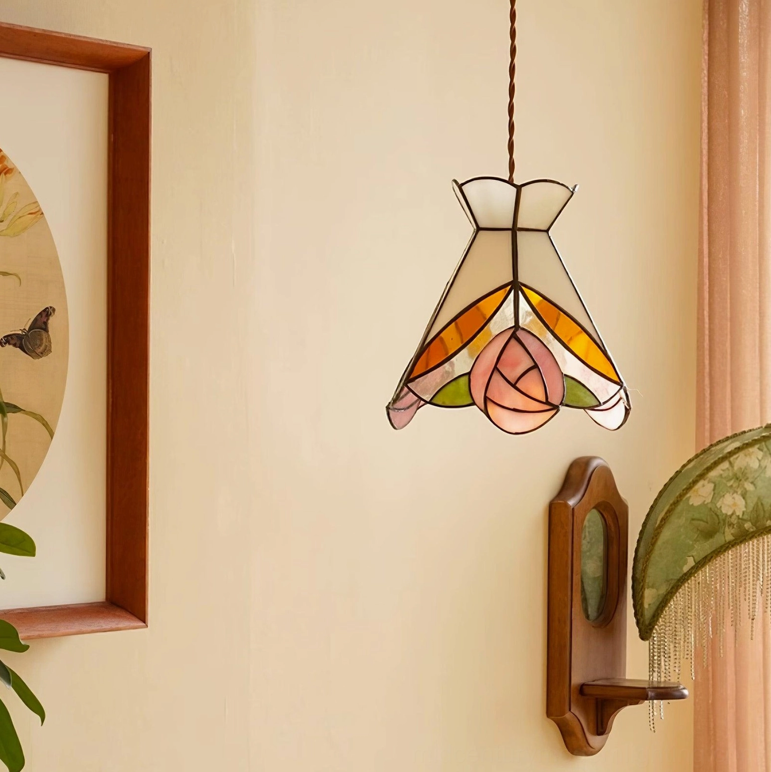 Tiffany pendant light with floral stained glass design showing brass framework and suspension hardware