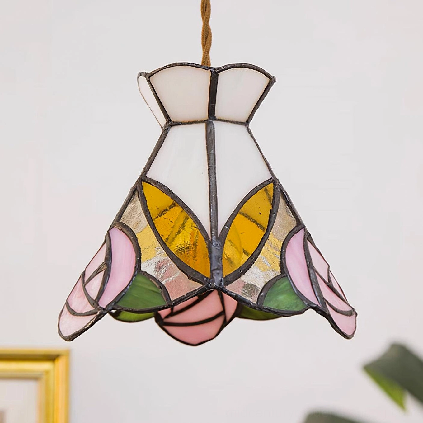Detailed close-up of Tiffany stained glass rose panels with brass framework and metal construction