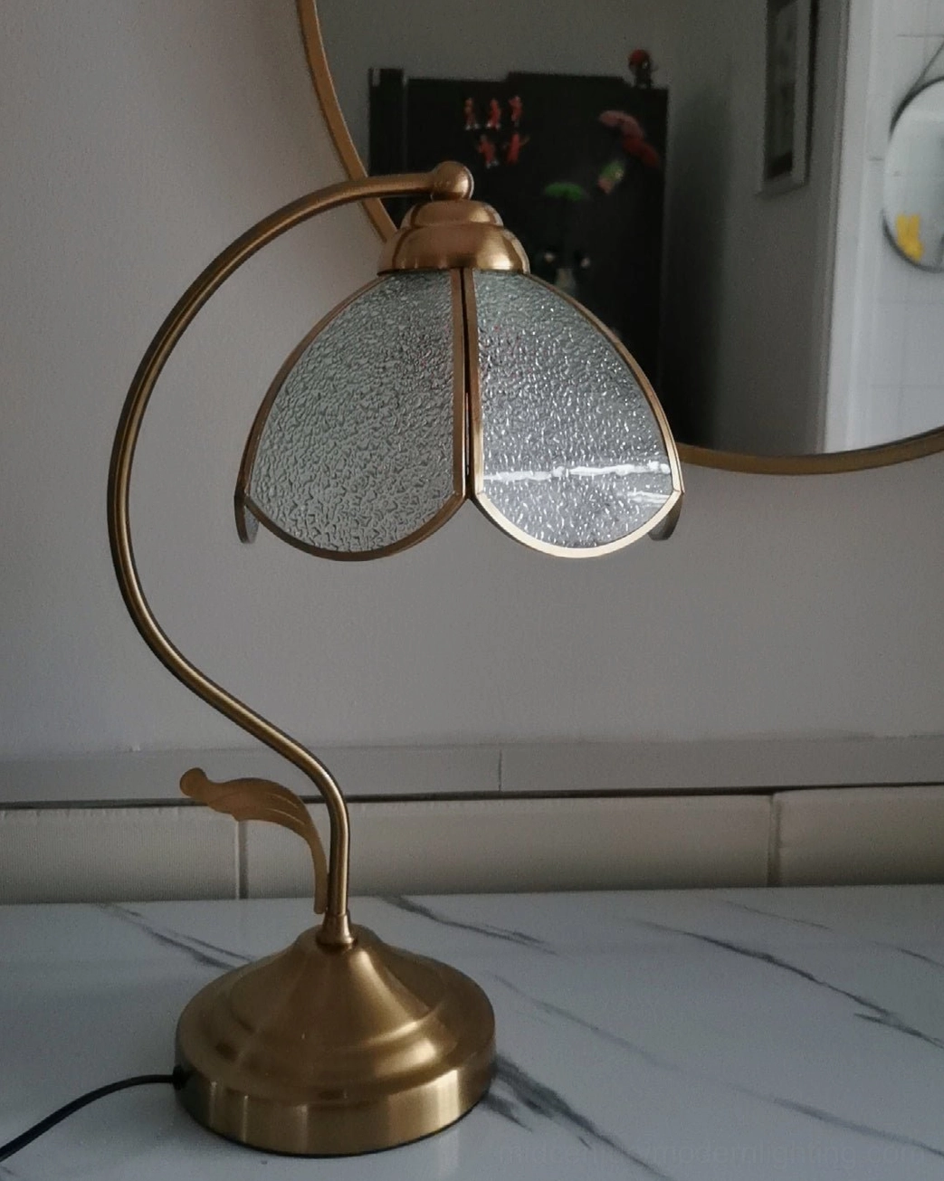 Full product shot of Tiffany-style table lamp showing complete frosted glass shade and brass frame assembly