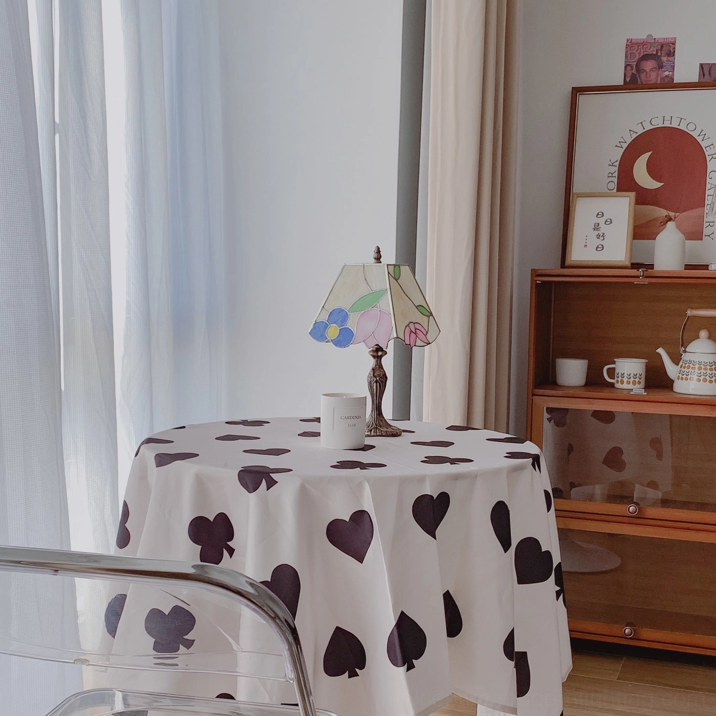 Art Nouveau Tiffany lamp on dining table with heart pattern tablecloth and wooden cabinet