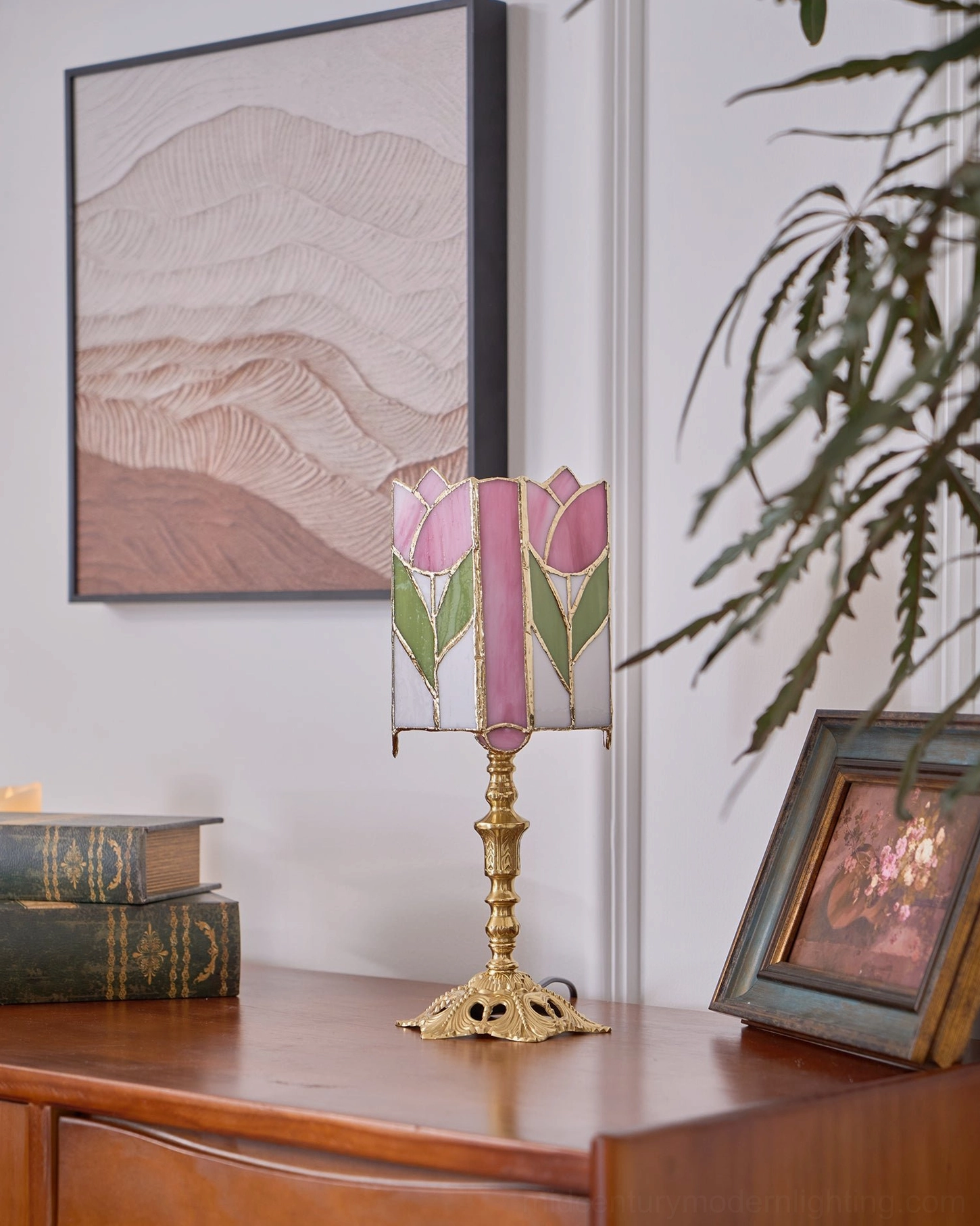 Tiffany tulip glass lamp with warm brass metal base and pink-green stained glass shade detail photography