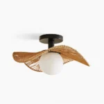 Tilda rattan ceiling lamp with wavy woven hemp shade, matte black base, and frosted white glass bulb - studio front view