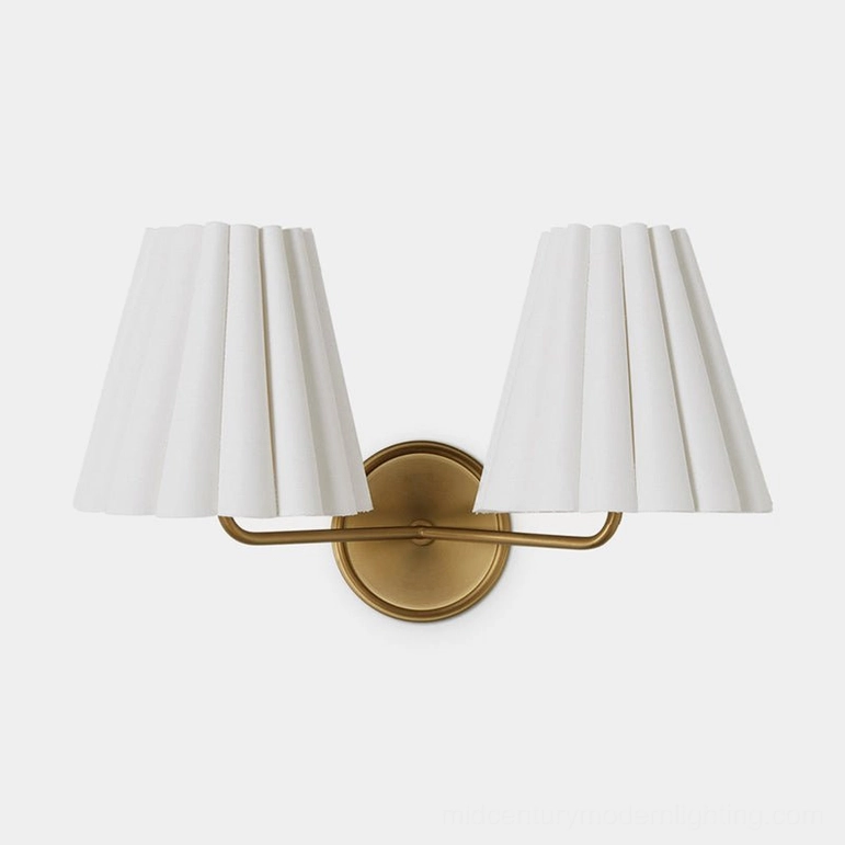 Tilia brass and white wall sconce variant in contemporary bedroom setting with minimalist decor