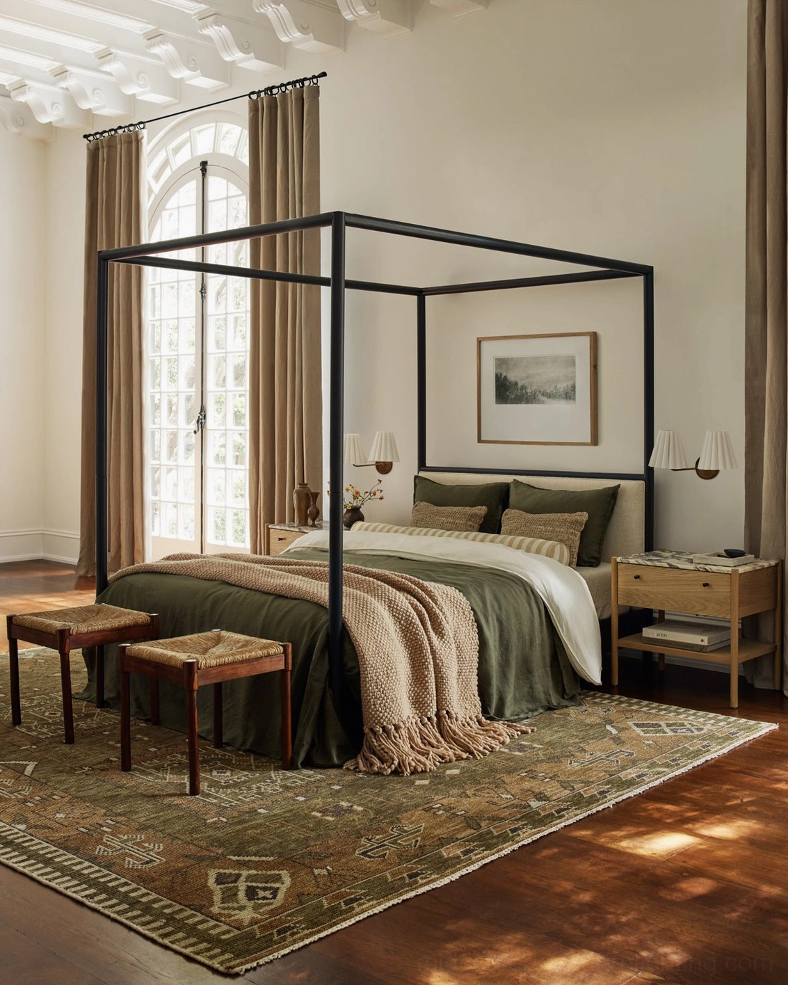 Traditional master bedroom with Tilia sconces, four-poster bed, layered bedding and area rug