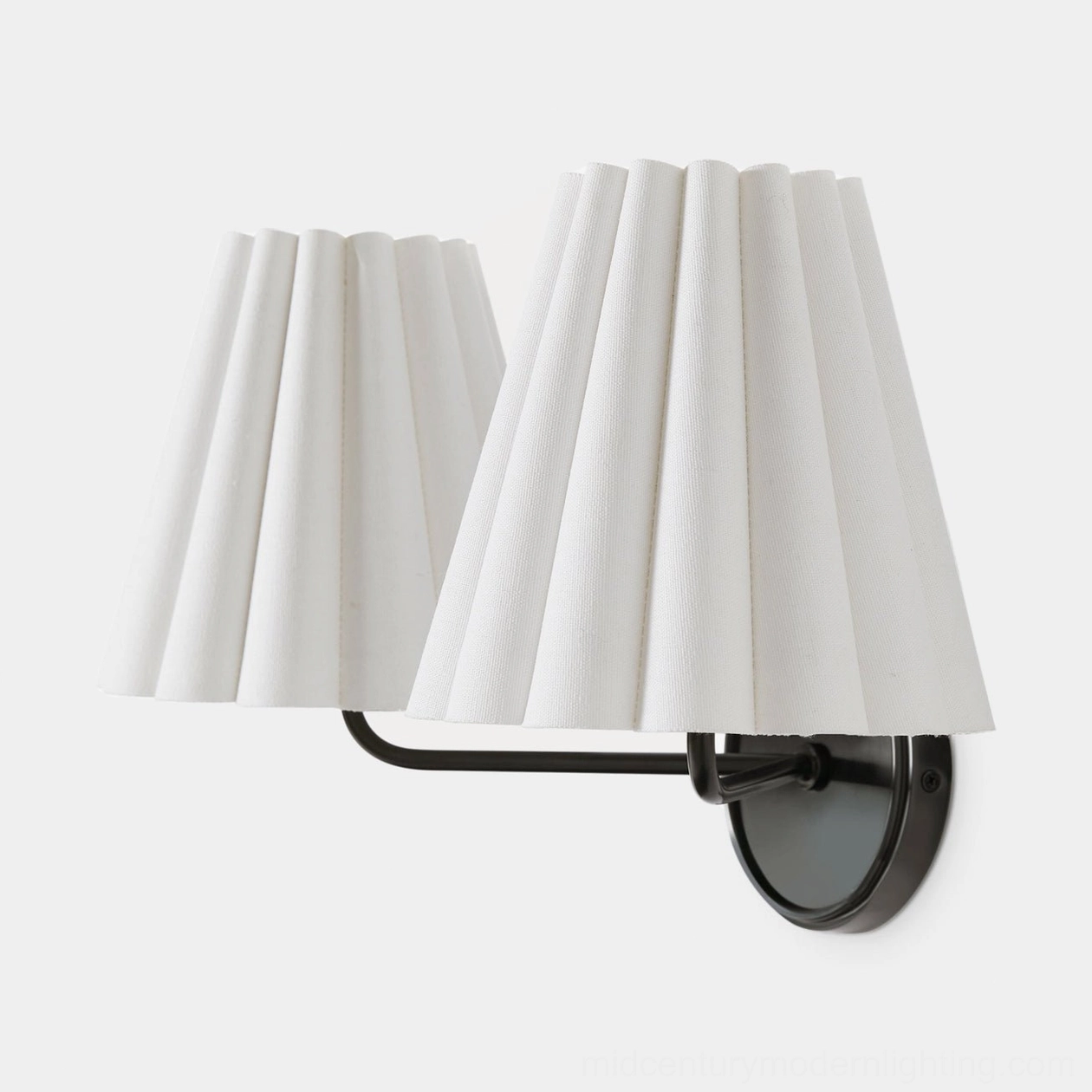 Tilia wall sconce close-up detail of pleated white fabric shade and brass mounting hardware
