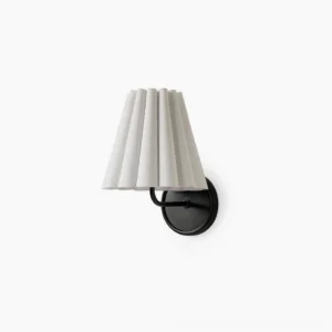 Tilia brass and fabric wall sconce with pleated white shade on studio background, mid-century modern design