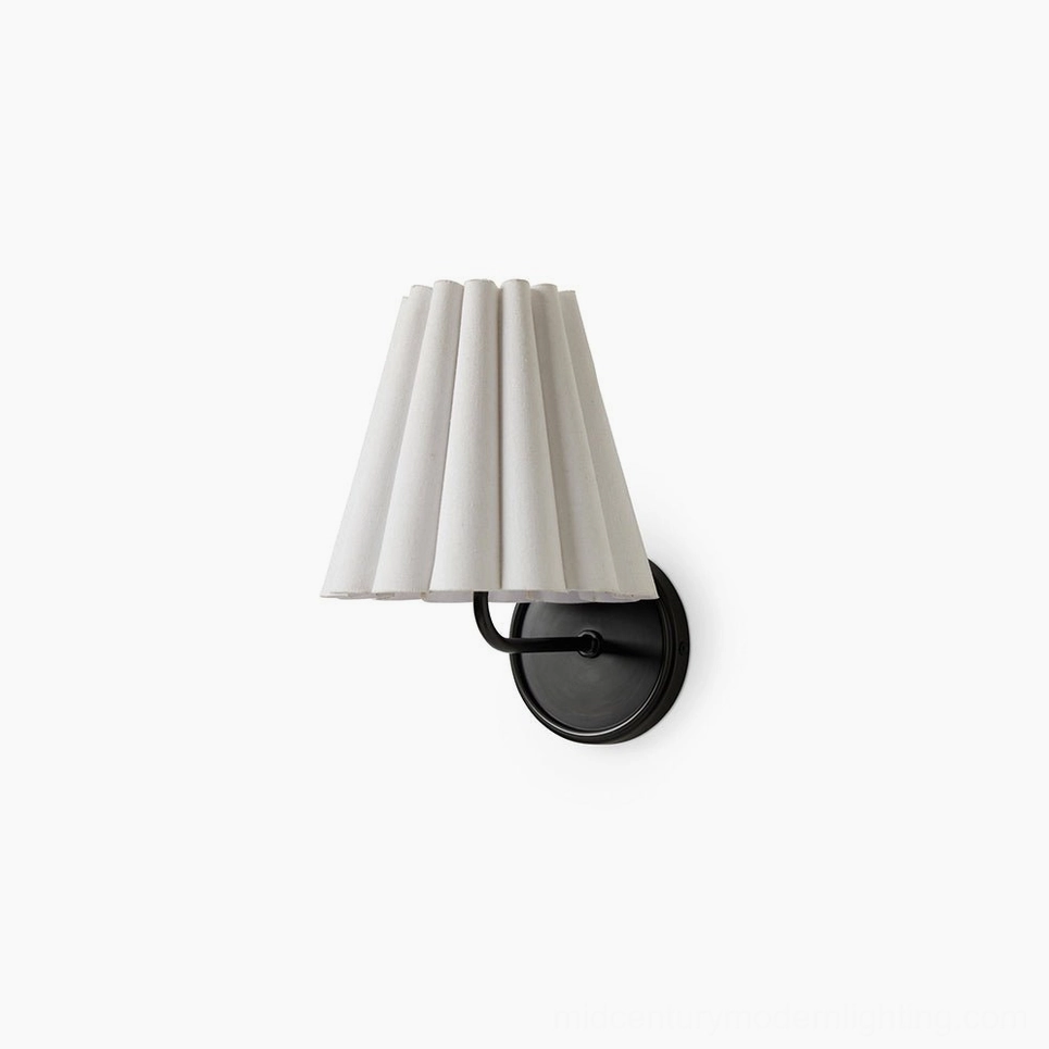 Tilia brass and fabric wall sconce with pleated white shade on studio background, mid-century modern design