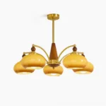 Tillary 5-head wood and brass chandelier with clear glass shades, front overhead view on white background