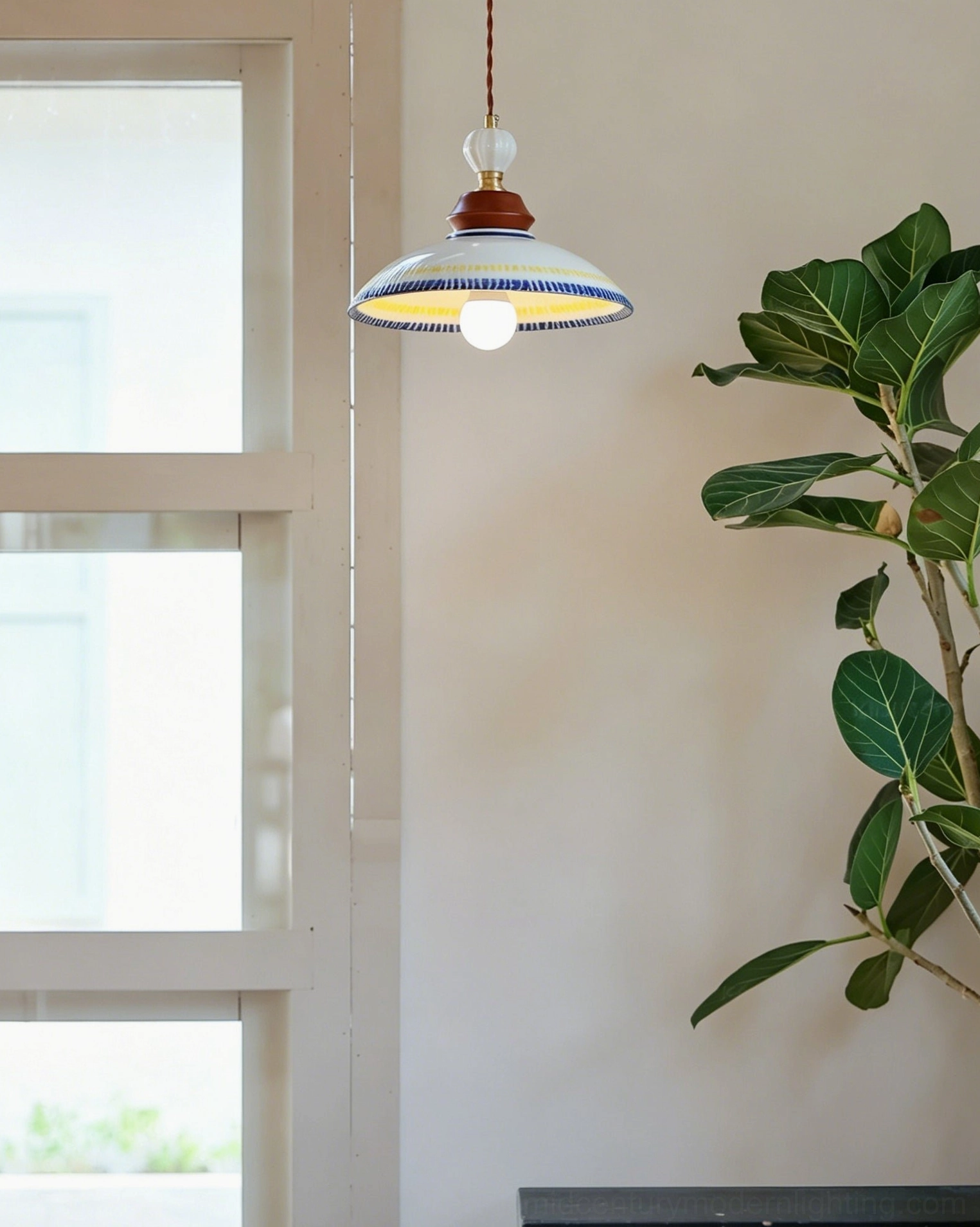 Close-up detail of Tilly ceramic pendant suspension showing decorative glass bead accent on twisted cord with white porcelain shade and blue-yellow striping