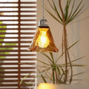 Tiro pendant light installed in mid-century modern interior with warm glow from vintage Edison bulb, side angle with louver window