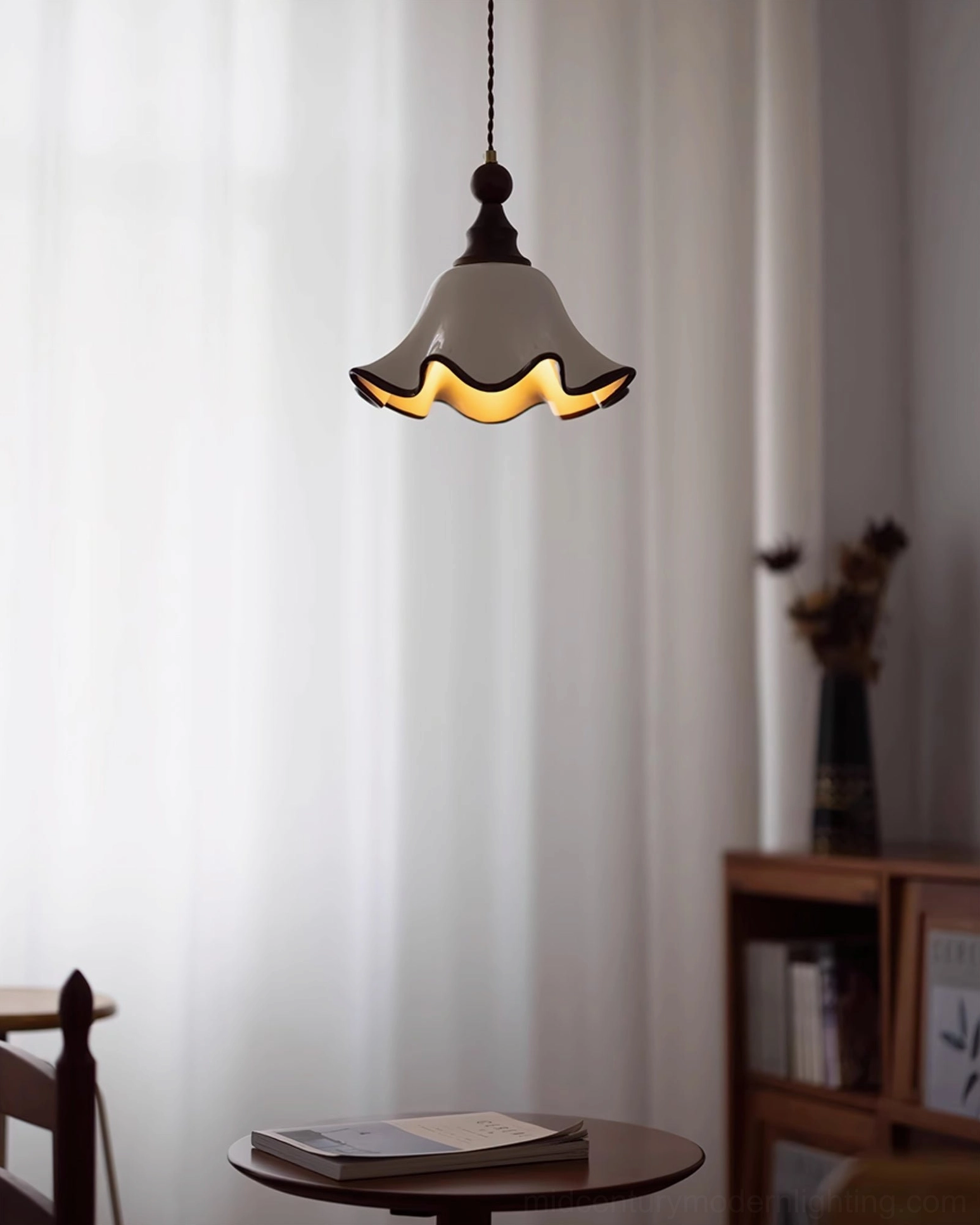 Toledo wavy ceramic pendant lamp with warm interior glow in cozy vintage reading nook setting